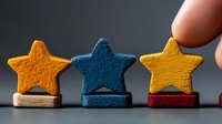 Hand placing wooden star blocks in row showing customer feedback rating system for business quality assessment and service evaluation concepts.