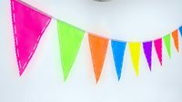 Colorful bunting banner with bright neon pink, lime green, orange, blue, yellow, and magenta triangular flags strung together on white background for celebrations.