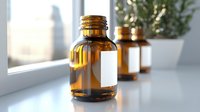 Empty amber glass medicine bottles on windowsill with natural light, selective focus on front bottle. Clean minimalist pharmaceutical composition.