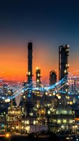 Industrial oil refinery plant with digital network connections at sunset showcasing smart factory technology and industrial automation systems.