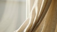 Elegant beige linen curtains with soft natural lighting creating warm atmosphere in modern interior design for home decoration and window treatment.