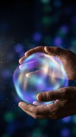 Hand holding glowing energy orb with blue and purple light effects against dark background. Concept for magic, future technology, innovation, and mystical power.