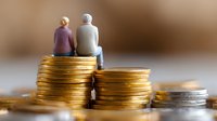 Senior couple sitting on stack of gold and silver coins, symbolizing retirement savings, pension funds and financial planning for elderly care and investment management.
