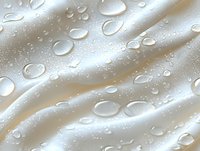 Clear water drops on white silky fabric creating natural pattern with light shadows and reflections, macro photography showing texture and liquid beading effect.