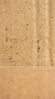 Natural brown recycled paper texture with visible fibers and organic imperfections for eco-friendly design projects and sustainable branding materials.