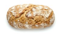Freshly baked artisan bread loaf with golden crust and flour dusting isolated on white background for bakery marketing and food design projects.