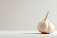 Fresh whole garlic bulb on white background with soft shadow, minimalist food photography composition showing natural texture and layers.