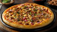 Freshly baked pizza with crispy golden crust topped with melted cheese, savory bacon, red onions, mushrooms and herbs on dark wooden serving board, close up view.