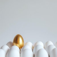 Golden egg stands out among white eggs in rows on light background, symbolizing uniqueness, success and leadership concept for business and finance designs.