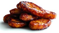 Caramelized banana slices with golden brown edges and glossy surface, perfect for desserts, breakfast toppings, and culinary presentations.