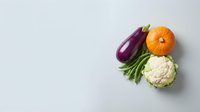 Fresh organic vegetables including eggplant, pumpkin, green beans and cauliflower arranged on white background for healthy cooking and nutrition concepts.