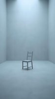 Single wooden chair positioned in empty minimalist room with white walls and floor, conveying isolation, loneliness, and absence. Suitable for conceptual, editorial, and psychological themes.