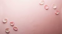 Delicate pink rose petals scattered on a soft pastel pink background, creating a romantic and elegant flat lay composition with copy space.