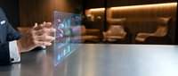 Businessman analyzing holographic financial data charts and graphs on transparent display in modern office environment for business analytics and reporting.