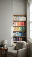 Cozy reading corner with wooden bookshelf filled with colorful books, comfortable beige armchair, and natural light from window in modern minimalist interior.