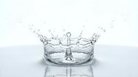 Water crown splash with droplets on reflective surface capturing motion and purity for commercial and artistic projects.