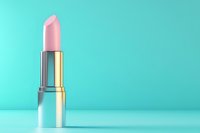 Pink lipstick in metallic silver case standing on mint green background. Minimalist beauty product photography with copy space for cosmetic advertising.