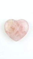 Rose quartz heart stone isolated on white background, polished gemstone with natural inclusions and faceted surface for wellness and spiritual design projects.