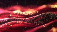 Glowing red and gold particles flow in waves creating magical atmosphere with bokeh light effects and sparkling dust. Abstract background for luxury designs.