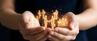 Family protection and insurance concept with glowing golden house and people icons held in cupped hands against dark background. Suitable for financial services, real estate, and security.