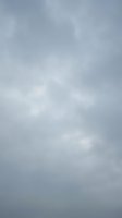 Overcast gray sky with soft white clouds creating moody atmospheric weather conditions for backgrounds and nature photography projects.
