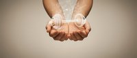 Hands holding glowing digital hologram spheres representing technology, innovation, and data transfer for business and communication concepts.