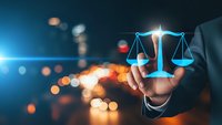 Professional businessman holding glowing scales of justice symbol representing legal services, law firm consultation, and corporate legal advice solutions.