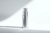Silver cosmetic serum bottle with pump dispenser on white surface with dramatic shadow lighting for skincare and beauty product marketing.