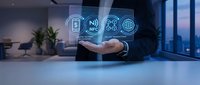 Businessman holding NFC and wireless payment technology icons above hand in modern office with city skyline view, representing digital transaction solutions.