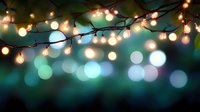 String lights creating magical bokeh effect against dark turquoise background, glowing warm bulbs illuminate night atmosphere for festive holiday decor.