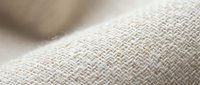 Close-up of natural linen fabric with herringbone weave texture, ideal for interior design, textile, and home decor projects.