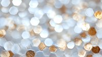 Shimmering hexagonal bokeh pattern in silver and gold creates magical festive background with soft defocused lights and geometric shapes for holiday designs.