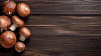 Fresh brown mushrooms arranged on rustic wooden background with copy space for culinary and cooking projects.