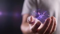 Close-up of hand holding glowing purple energy orb with electric lightning effects, representing power, magic, technology, and innovation for digital concepts.