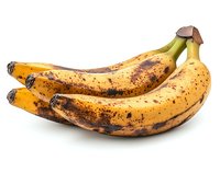 Ripe spotted bananas with brown marks on yellow peel isolated on white background, showing natural aging process and peak sweetness for baking and cooking.