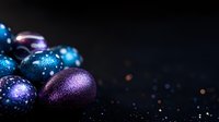 Festive Christmas ornaments in shimmering blue and purple with glitter effect against dark background, creating magical holiday atmosphere.