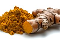 Fresh turmeric root and ground powder spice on white background, showing natural organic ingredients for cooking, wellness and health benefits.