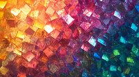 Vibrant mosaic of colorful glass tiles glowing in rainbow hues, from warm orange and red to cool blue and green, creating a dazzling texture.