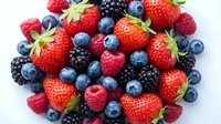 Fresh mixed berries collection with strawberries, blueberries, blackberries and raspberries on white background for healthy eating and nutrition concepts.