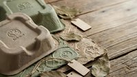 Handmade natural soap bars with herbal leaves on rustic wooden background for organic skincare and spa treatments.