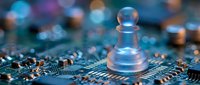 Transparent chess pawn piece on computer circuit board with colorful bokeh lights representing strategic technology planning and digital business decisions.