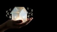 Hand holding glowing house model with floating currency symbols representing real estate investment, mortgage loans, property financing and home economics.