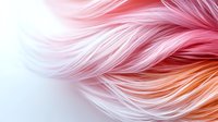 Soft flowing strands in pink and peach gradient colors create ethereal feather-like texture against white background, macro photography style composition.