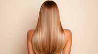 Young woman with long straight blonde hair shown from behind against beige background. Smooth, healthy hair styling demonstrates professional haircare and beauty treatment results.