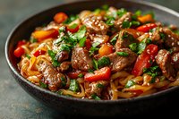 Tender beef stir fry with colorful bell peppers, carrots, and noodles in savory Asian sauce, garnished with fresh herbs in dark ceramic bowl on rustic background.