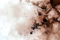 Abstract brown and black ink drops spreading in water creating organic flowing shapes and delicate patterns against white background. Artistic fluid texture.