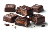 Dark chocolate candy squares with caramel and nougat filling, cut in half showing layers. Scattered pieces on white background for confectionery advertising.