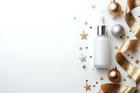 Luxury skincare serum bottle with dropper surrounded by gold and silver ornaments, stars, and glittery ribbon on white background for cosmetics marketing.