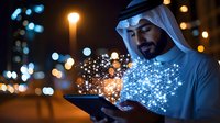 Middle Eastern businessman in traditional dress using digital tablet with glowing network visualization effect against night city lights background, representing digital transformation.