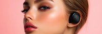 Young woman with glossy makeup and wireless earbuds on pink background. Modern beauty portrait with highlighted skin and bold lips for cosmetics advertising.